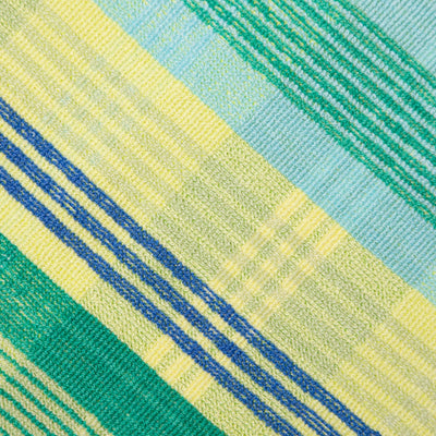 Close-up of a fabric with green, blue, and yellow striped pattern
