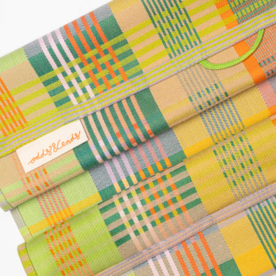 Folded kitchen teatowel with plaid pattern on a white background