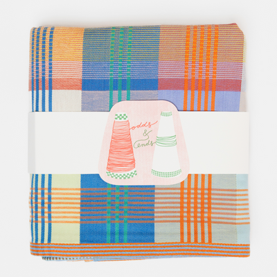 Folded fabric with plaid pattern on a white background