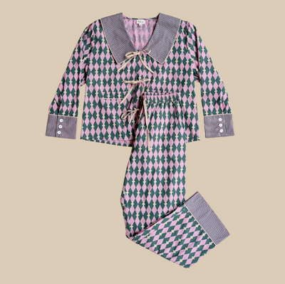 Harlequin-patterned pajama set on a beige background