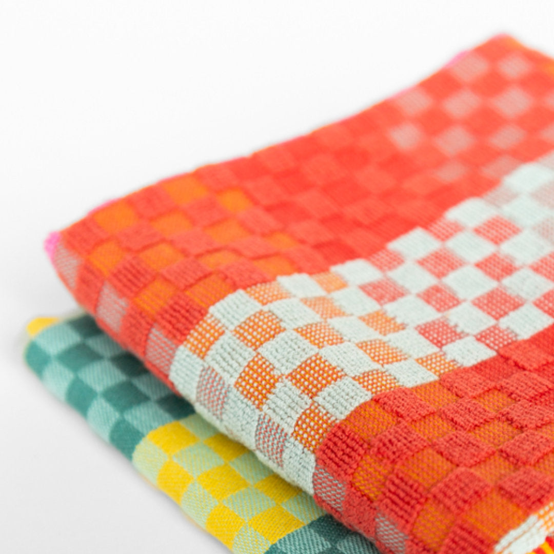 two kitchen towels with brightly coloured checks
