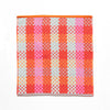 square kitchen cloth, brightly coloured with shades of red, pink, turquoise, orange and mint on a white background