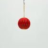 Red decorative ball hanging on a white background