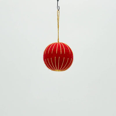 Red decorative ball hanging on a white background