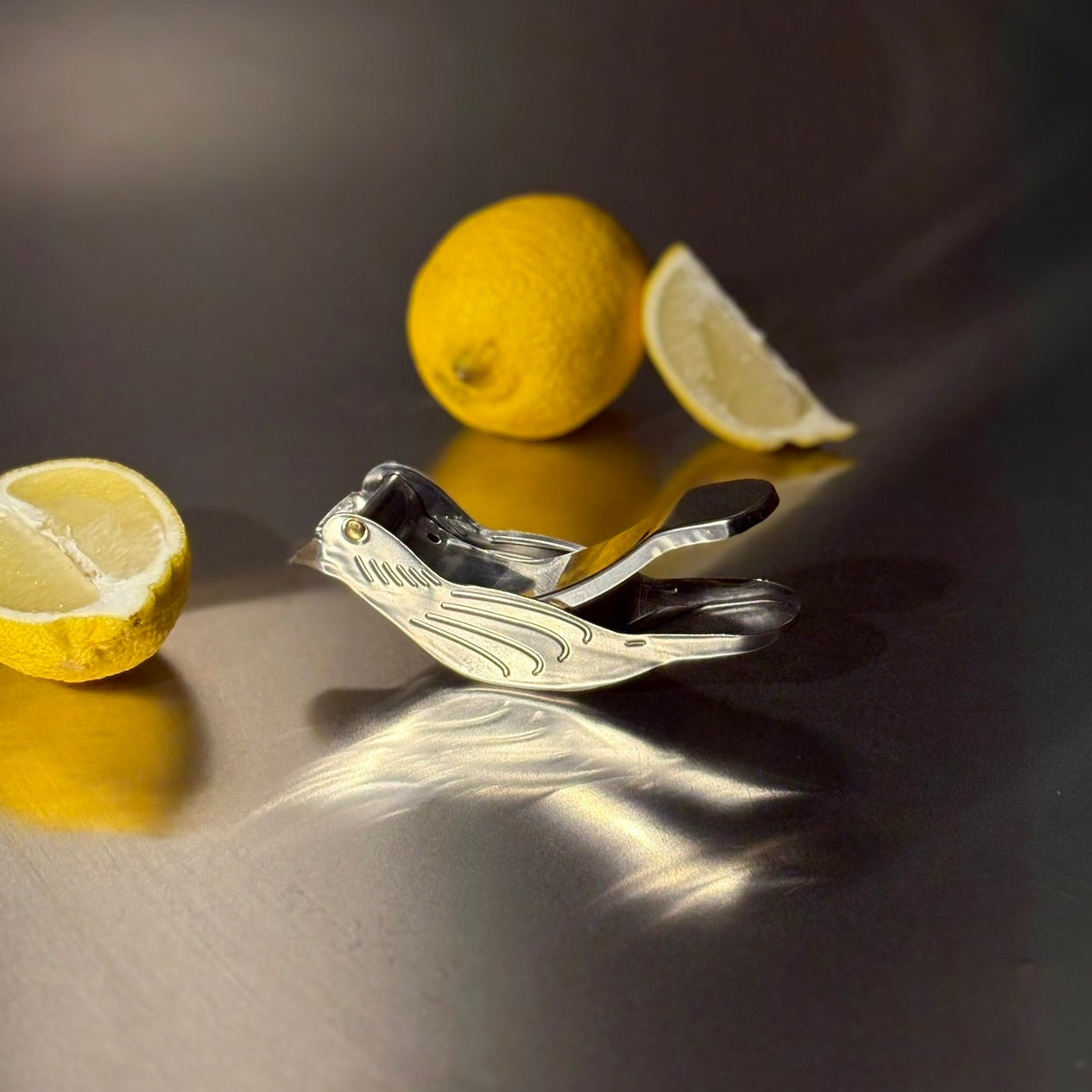 lemon squeezer in shape of a bird, with lemons