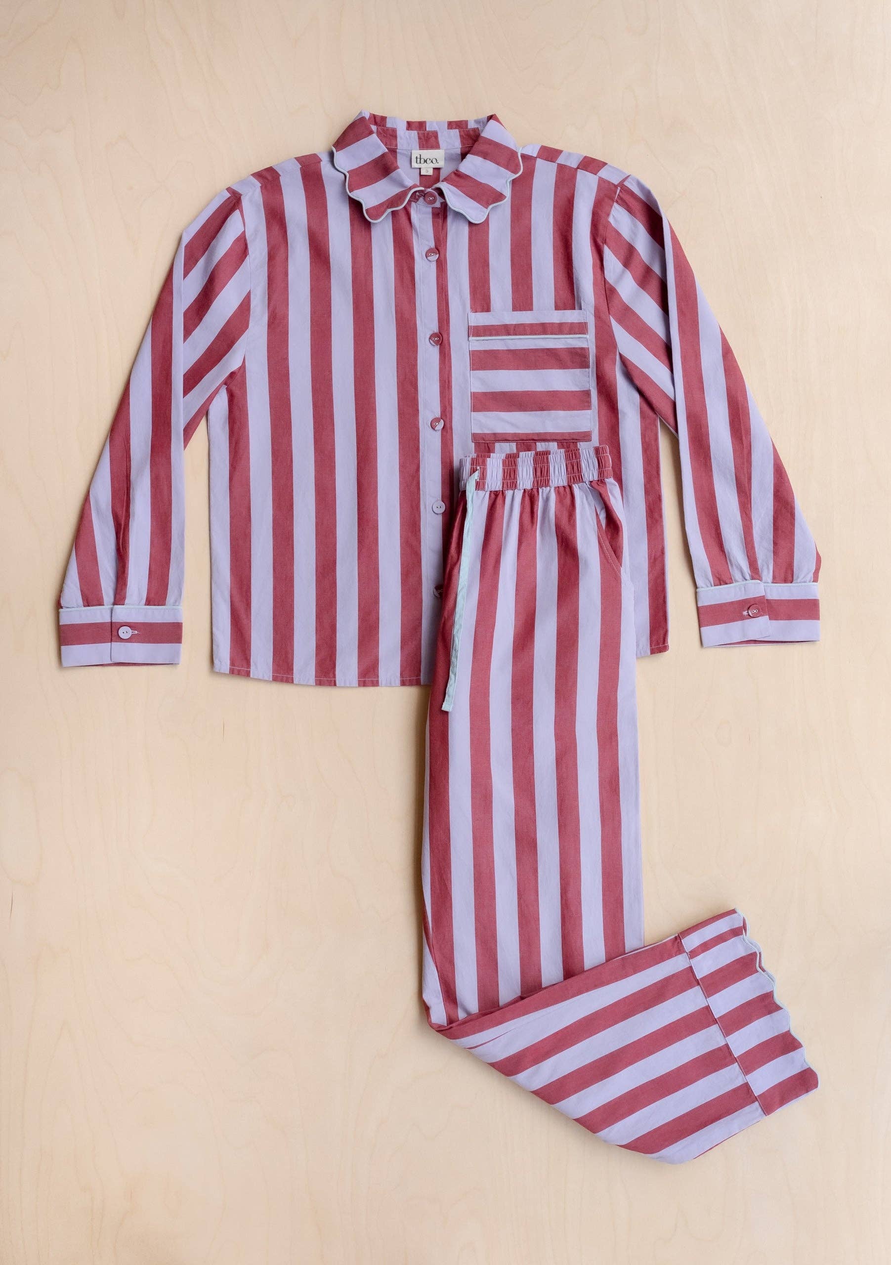 Red and white striped pajama set on a beige background