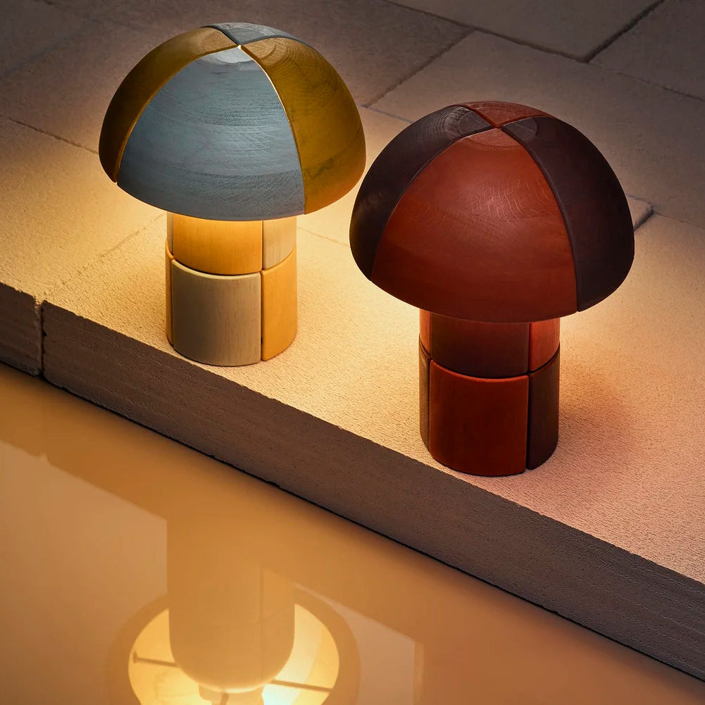 Two colorful mushroom-shaped lamps on a light surface.