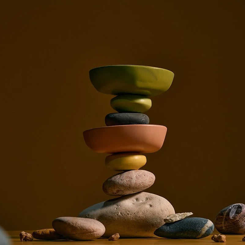 Stack of colorful wooden bowls with a brown background