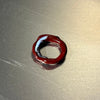 Red glass ring on a metallic surface