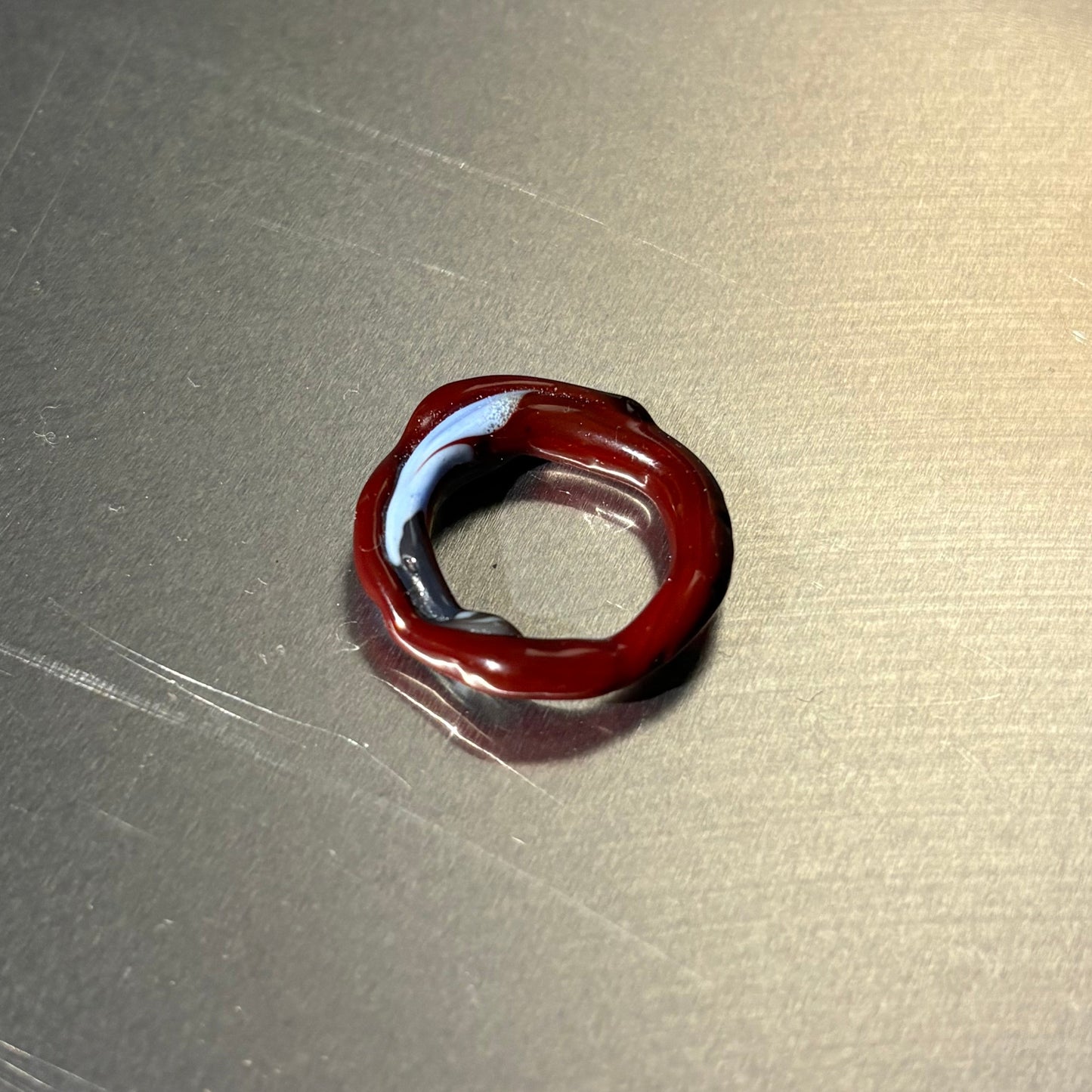 Red glass ring on a metallic surface