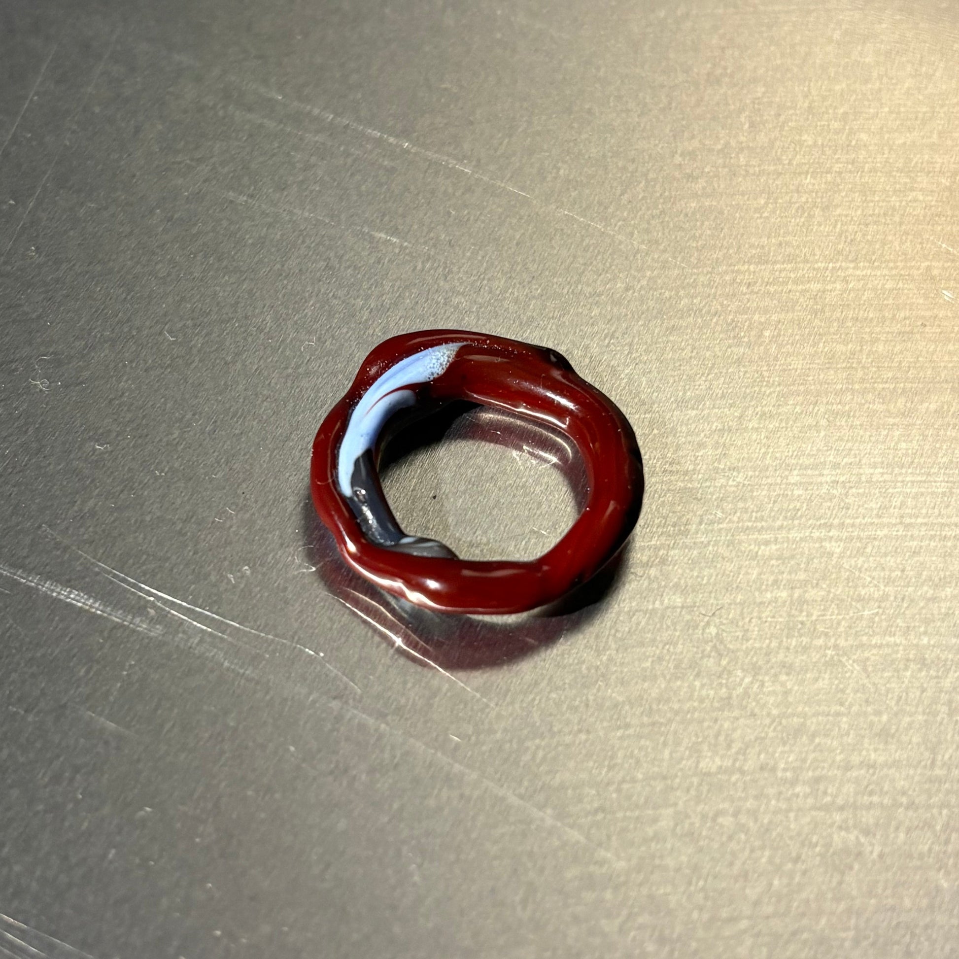 Red glass ring on a metallic surface