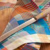 Colorful plaid fabric with a bread knife 