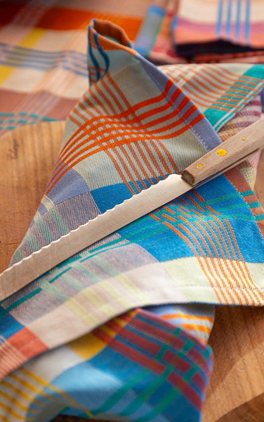 Colorful plaid fabric with a bread knife 