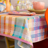 Colorful checkered tablecloth on a table with a blurred background