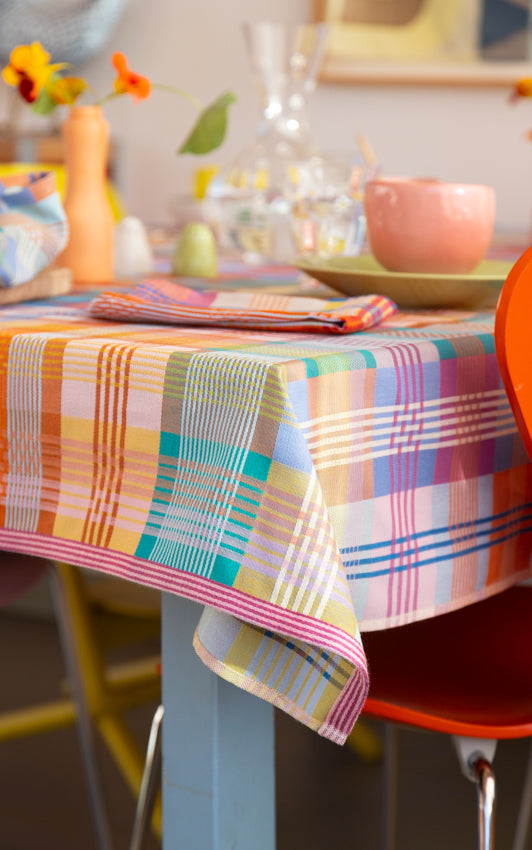 Colorful checkered tablecloth on a table with a blurred background
