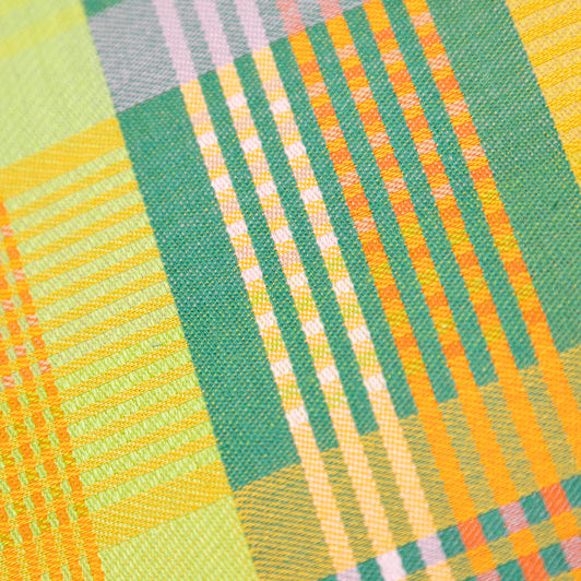 Close-up of a fabric with green and orange plaid pattern