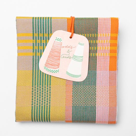 Colorful woven fabric with a tag on a white background