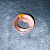 Coloured glass ring on a textured gray surface