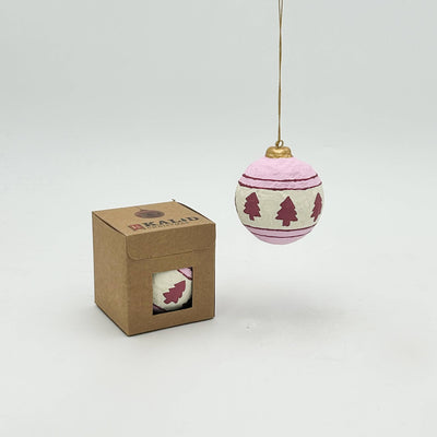 Decorative Christmas ball with tree pattern and packaging on a white background