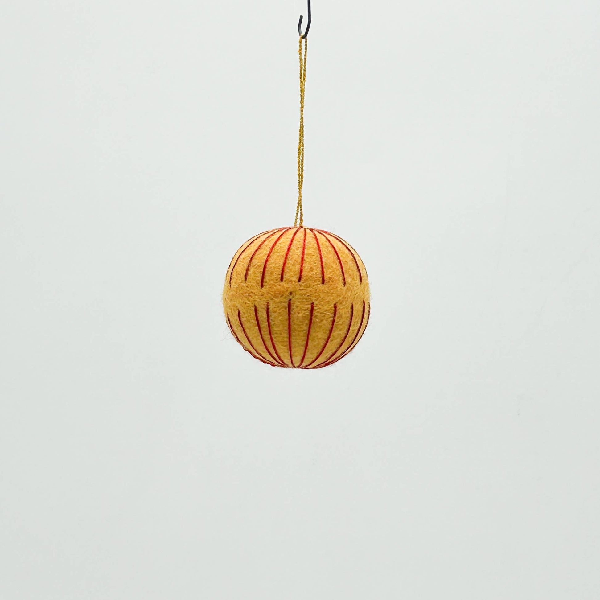 Yellow spherical hanging toy on a white background