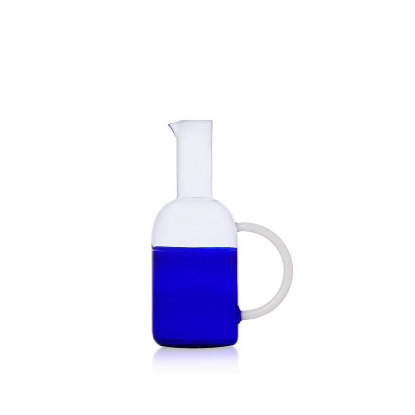 blue sunrise carafe by design studio Mist-O, a two toned carafe in blue and clear glass, with a white rounded large handle, photographed on a white background