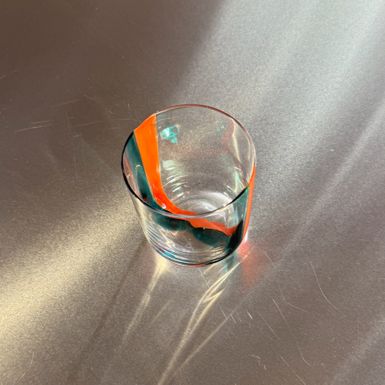 Clear glass on a reflective metallic surface