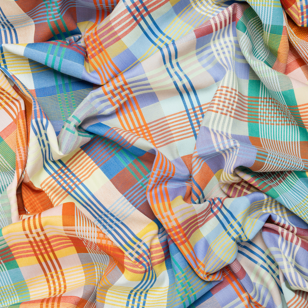 Colorful plaid fabric with a mix of orange, blue, green, and white.