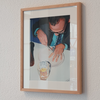 Framed picture of a person cutting a lemon on a white plate with a glass of water.