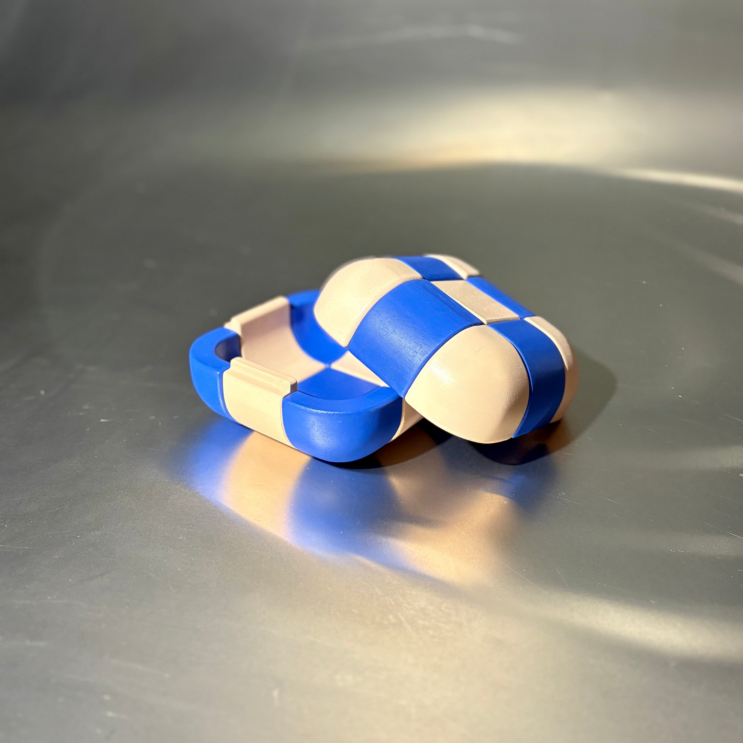 blue and cream coloured wooden box, laying open on a stainless steel surface