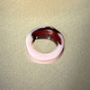 Two-tone ring with pink and brown on a beige background