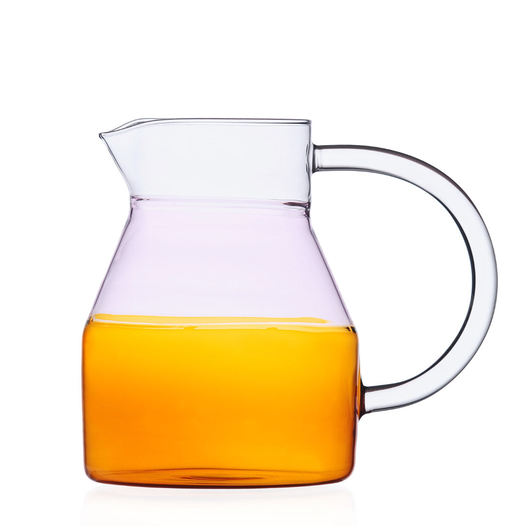 amber and pink hued serving carafe by Mist-O design studio. photographed on a white background