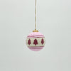 Decorative Christmas ball ornament with tree pattern on a light gray background