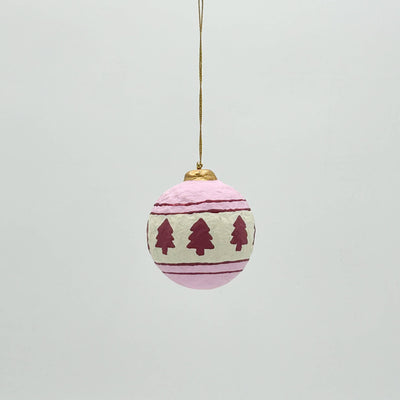 Decorative Christmas ball ornament with tree pattern on a light gray background