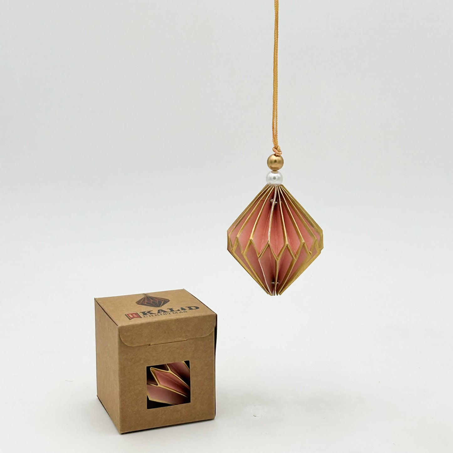 Decorative hanging ornament with a cardboard box on a white background