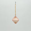 Decorative hanging ornament with geometric design on a light gray background