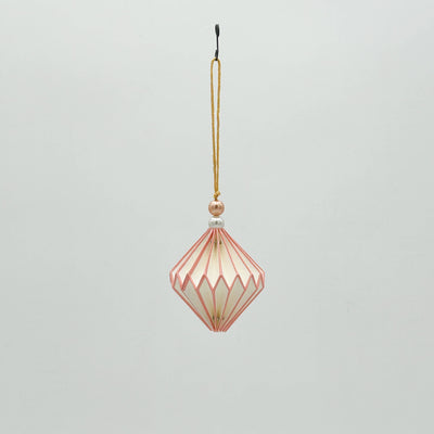 Decorative hanging ornament with geometric design on a light gray background