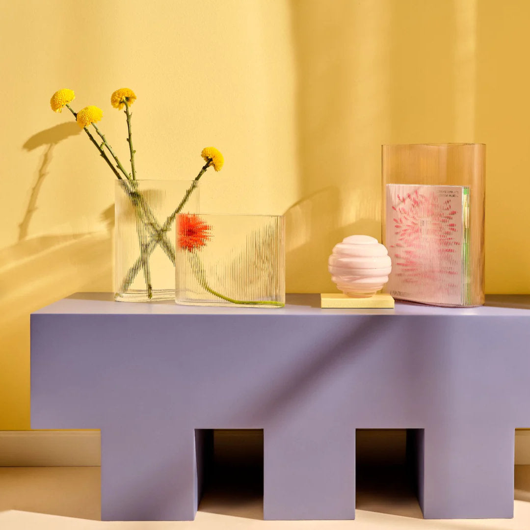 full set of the series "mist" vases by designer Tamer Nakisci, set against a bright yellow wall and lilac sidetable