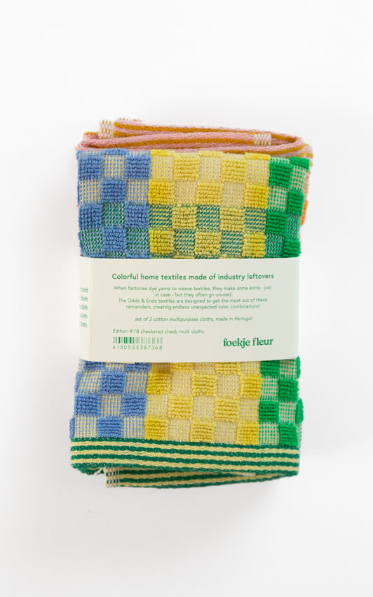 Odds and Ends multi cloth, checkered check design in primary and bright colours with a striped edge by Foekje Fleur,  limited edition number 18, pack of 2, seen here on a white background, photographed with the packaging label, from the back