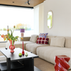 red and white striped vase with tulips in living room on coffee table