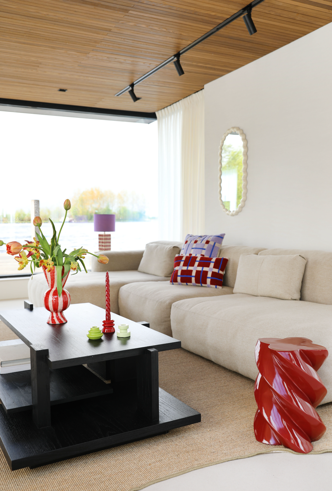 red and white striped vase with tulips in living room on coffee table