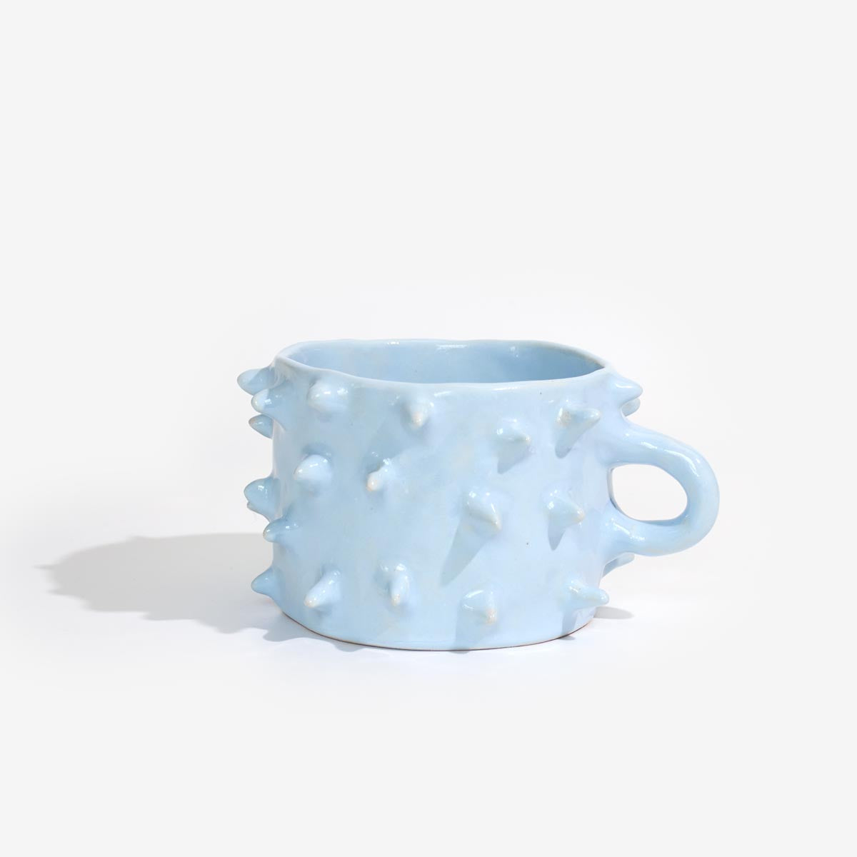Light blue mug with textured surface on a white background