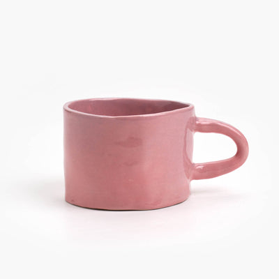 hand built ceramic mug with a rosé glaze, small handle with a wide brim mug