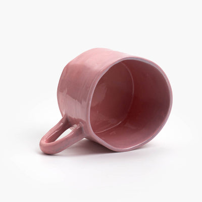 hand built ceramic mug with a rosé glaze, small handle with a wide brim mug