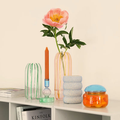 The sweep vase collection together with other decorative obects on a book case