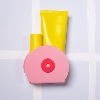 small bathroom boob shelf in pink with yellow plastic bottles - bathroom furnishings and accessories - nave shop - studio lecker 